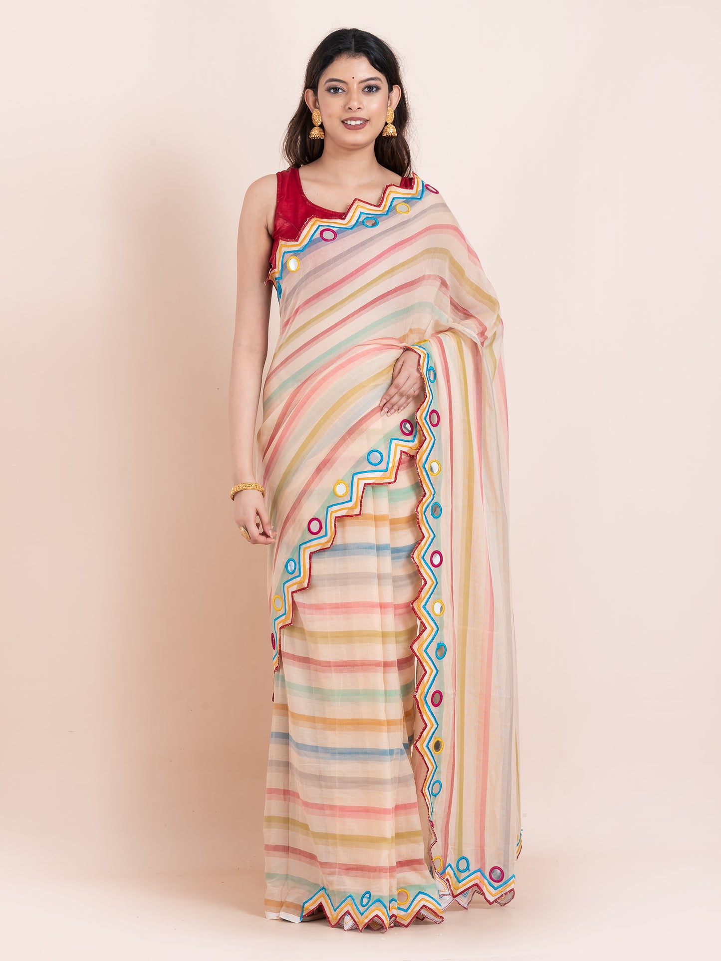 Lightweight peach mulmul cotton saree with mirror embroidery and multicolored stripes. Perfect for summer wear, festive looks, and effortless elegance.