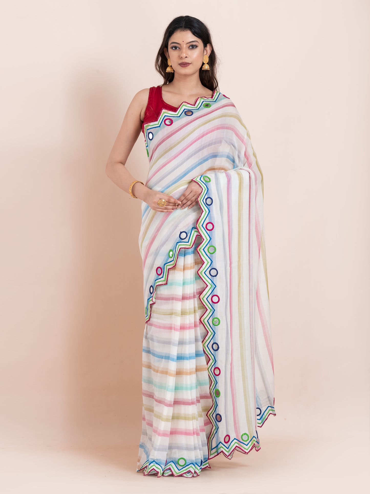 Lightweight white mulmul cotton saree with mirror embroidery and multicolored stripes. Perfect for summer wear, festive looks, and effortless elegance.