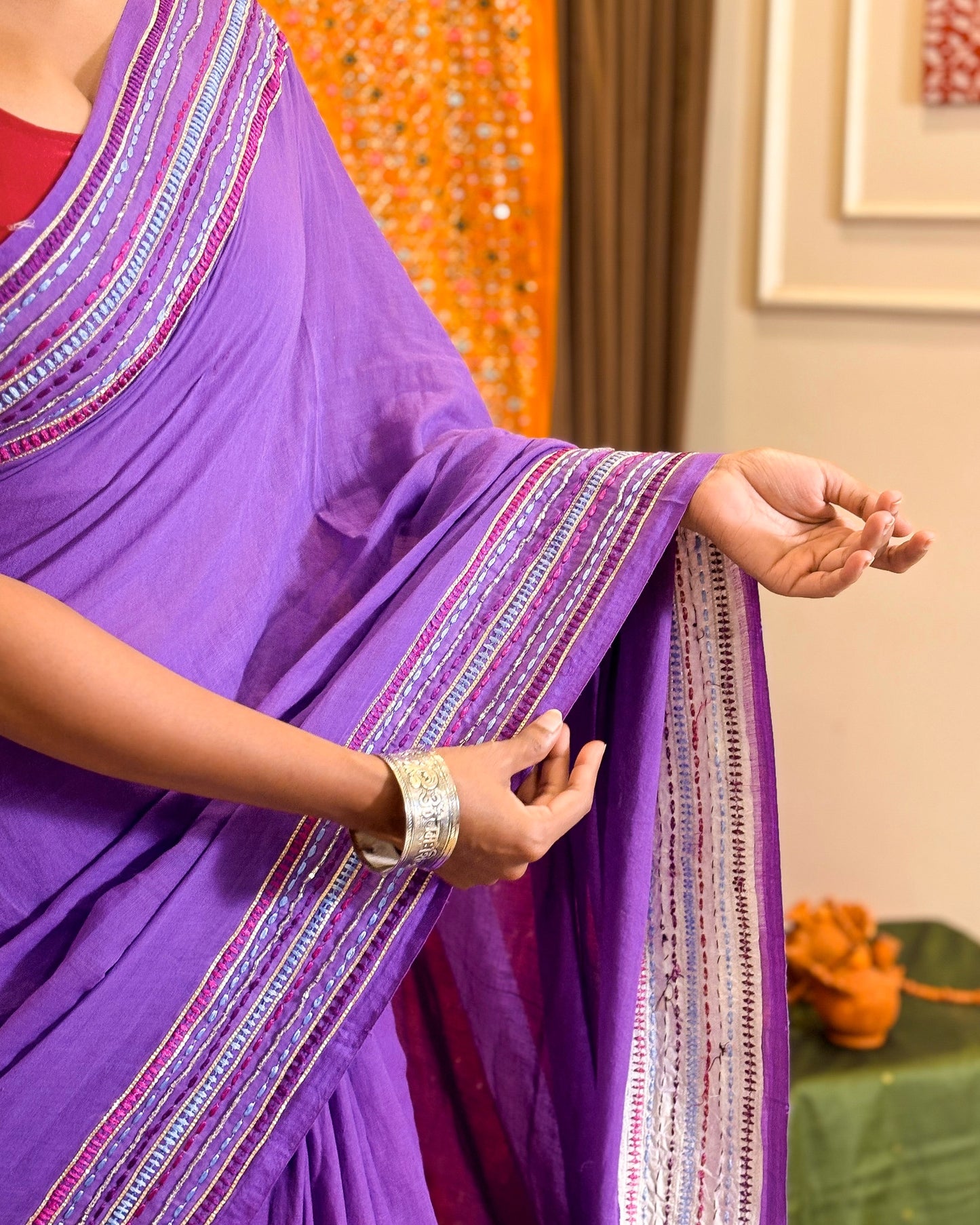 Woman in a black mulmul cotton saree with sequins embellished border - festive saree