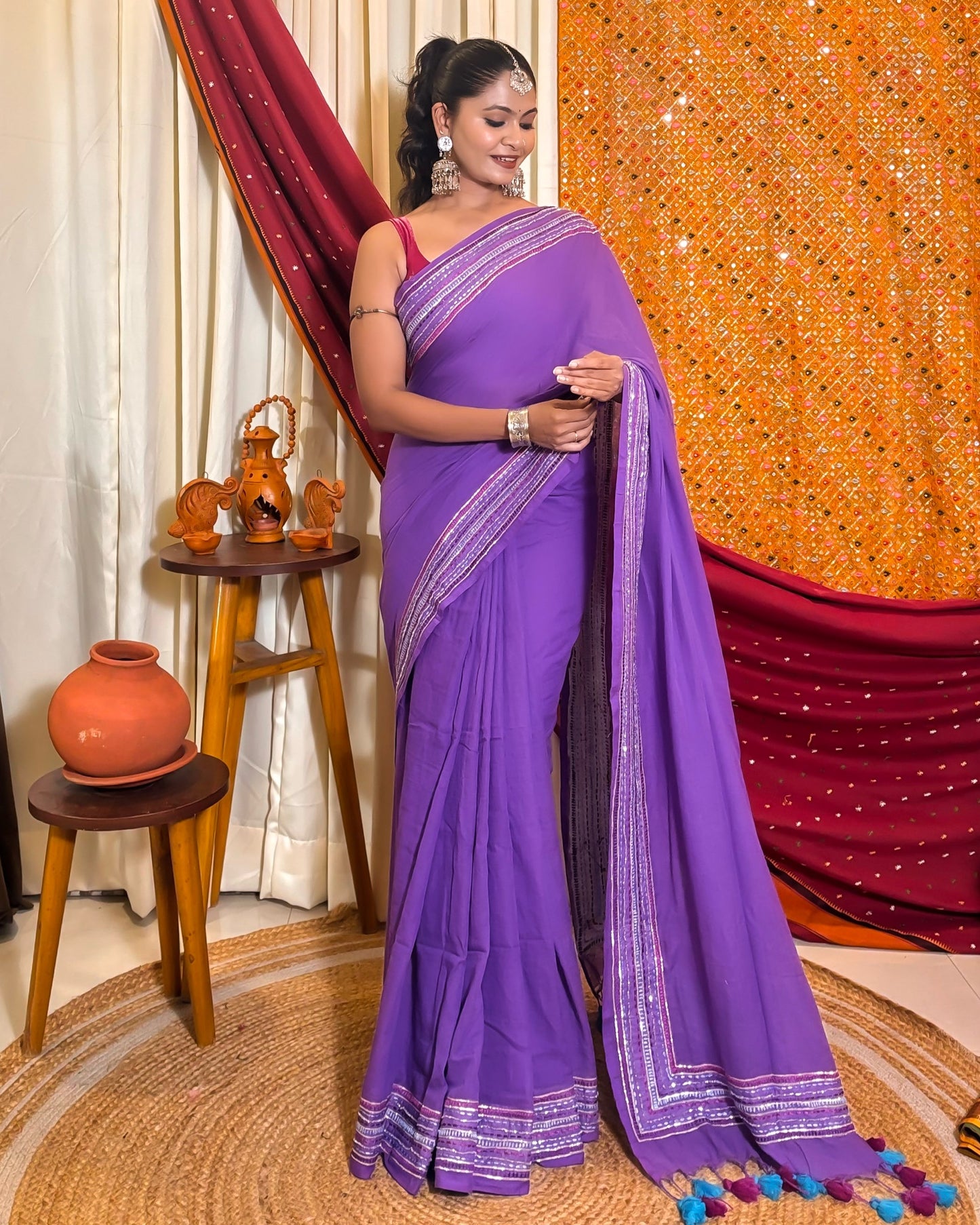 Woman in a black mulmul cotton saree with sequins embellished border - festive saree