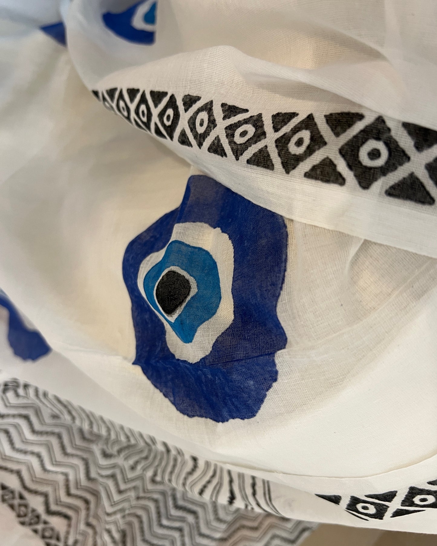 Soft & Comfortable white mulmul saree with handblock print in blue evil eye pattern