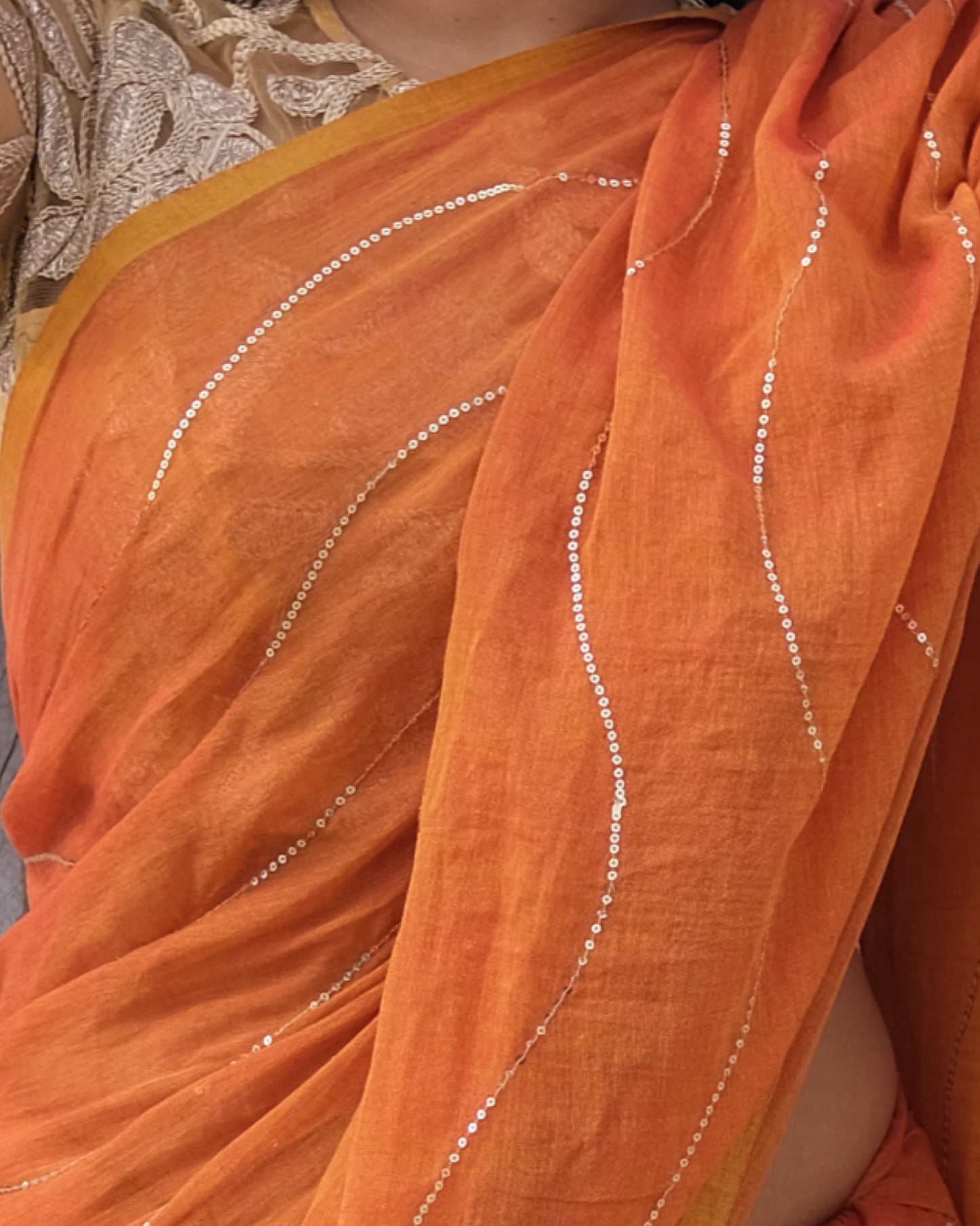 Soft and Comfortable mulmul cotton saree in dual tone mustard and orange shade with sequin emblishment for festive or party wear at reasonable price
