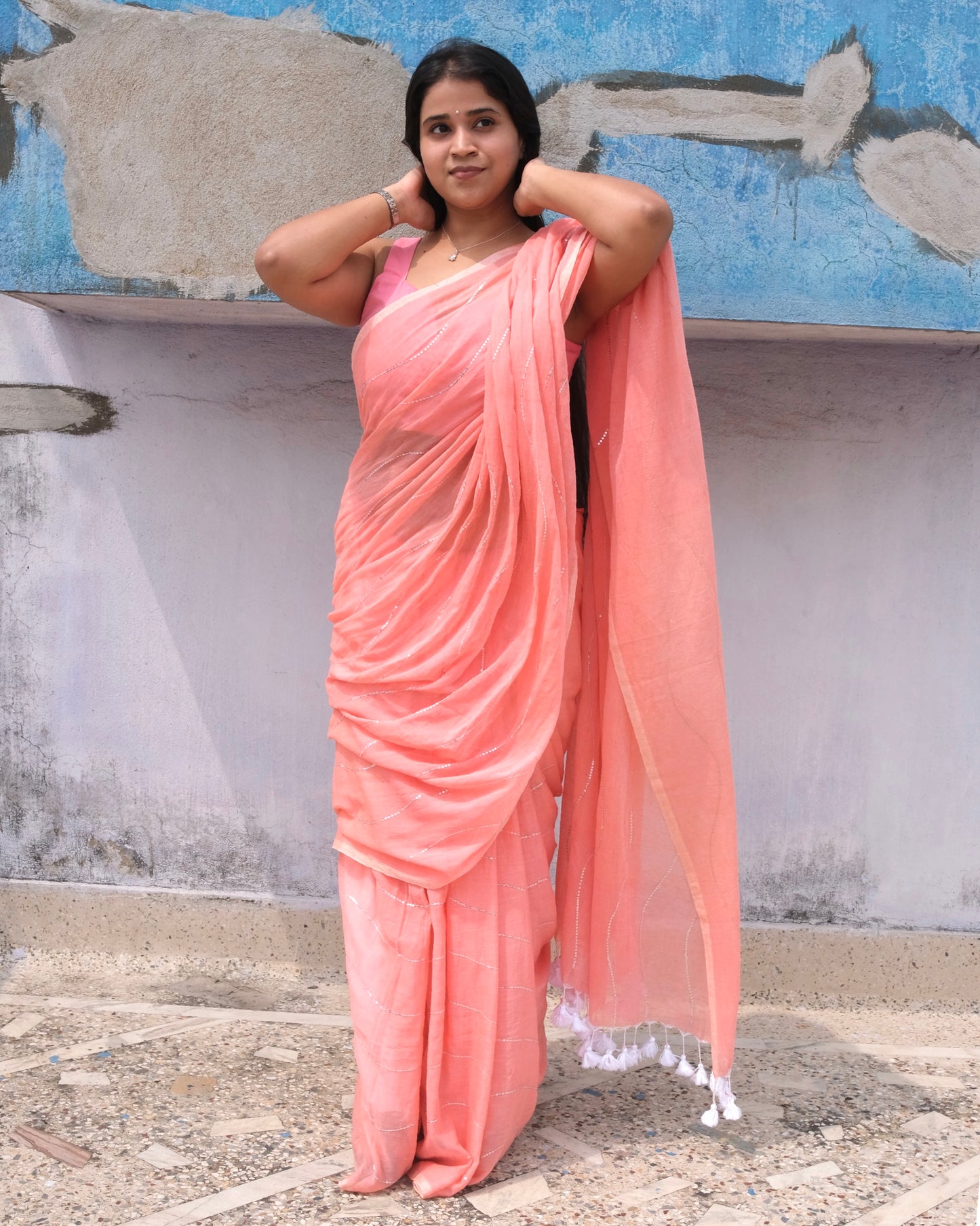 Soft and Comfortable mulmul cotton saree in peach pink shade with sequin emblishment for festive or party wear at reasonable price