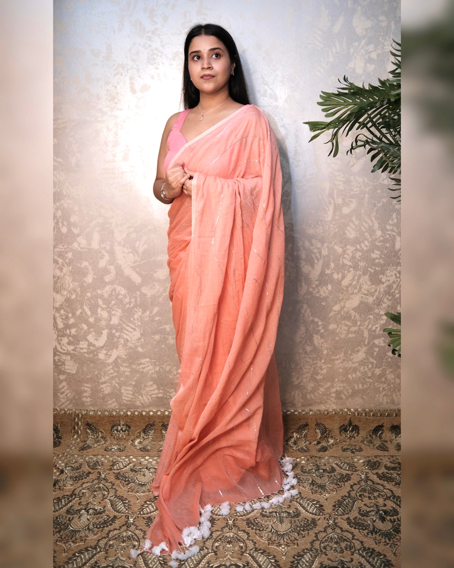 Soft and Comfortable mulmul cotton saree in peach pink shade with sequin emblishment for festive or party wear at reasonable price
