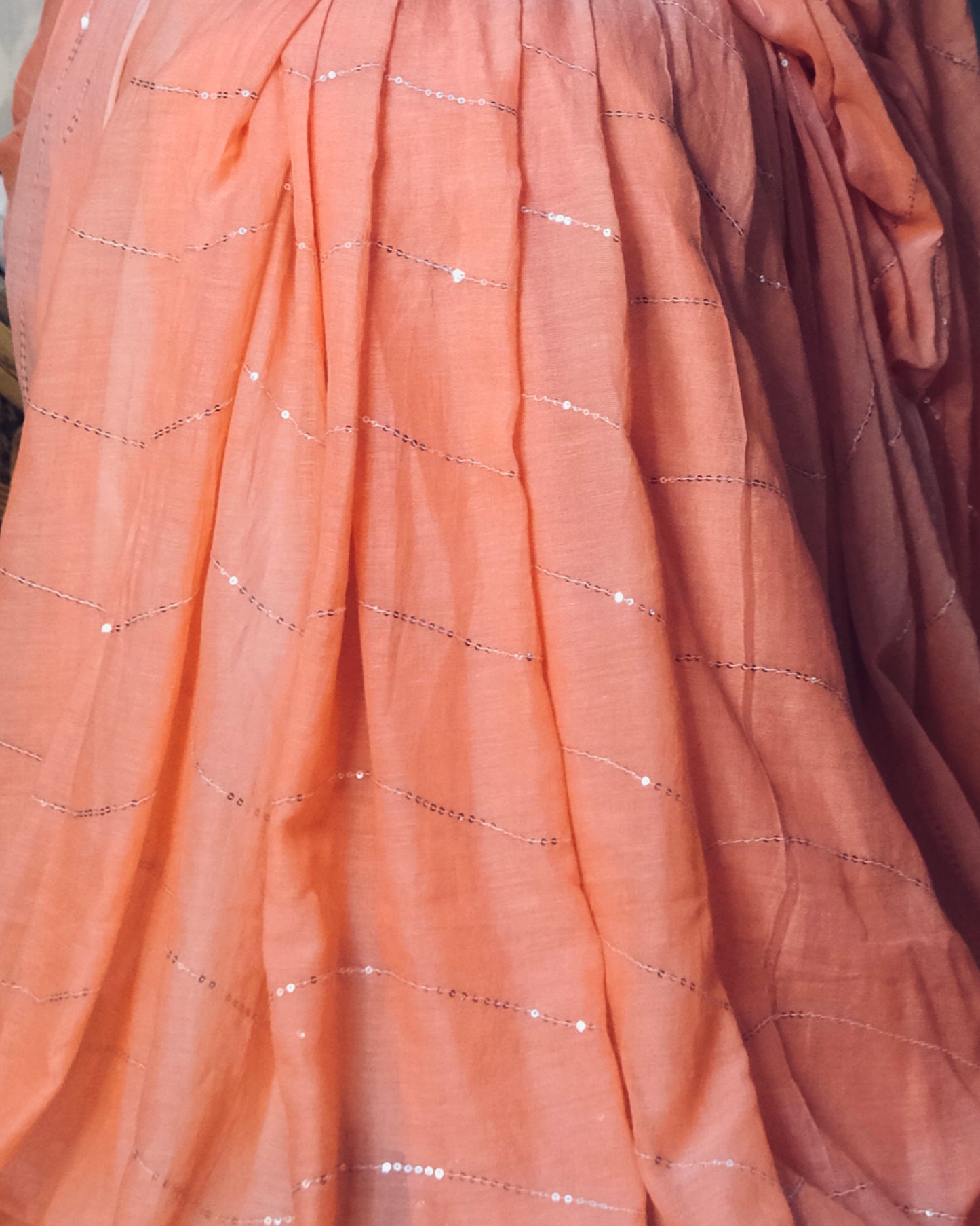 Soft and Comfortable mulmul cotton saree in peach pink shade with sequin emblishment for festive or party wear at reasonable price