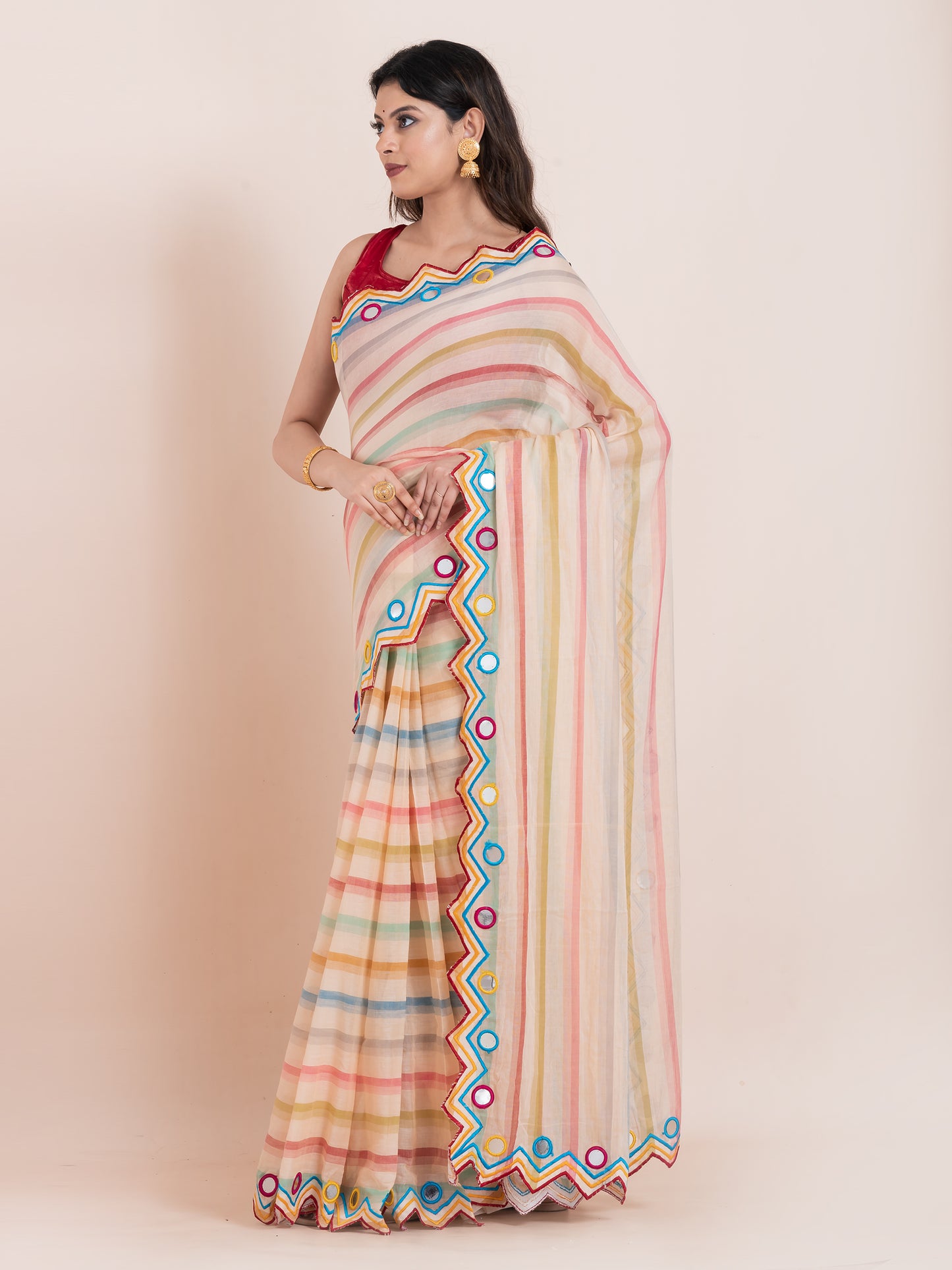 Lightweight peach mulmul cotton saree with mirror embroidery and multicolored stripes. Perfect for summer wear, festive looks, and effortless elegance.