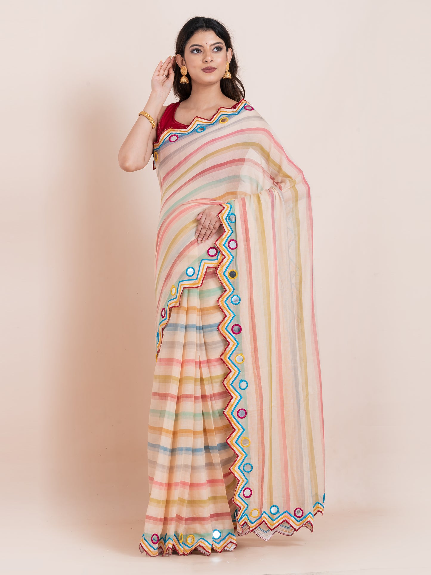 Lightweight peach mulmul cotton saree with mirror embroidery and multicolored stripes. Perfect for summer wear, festive looks, and effortless elegance.