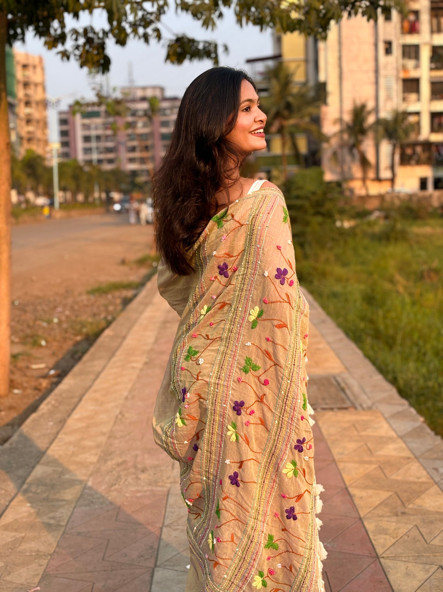 Beige mulmul cotton saree featuring elegant embroidered detailing