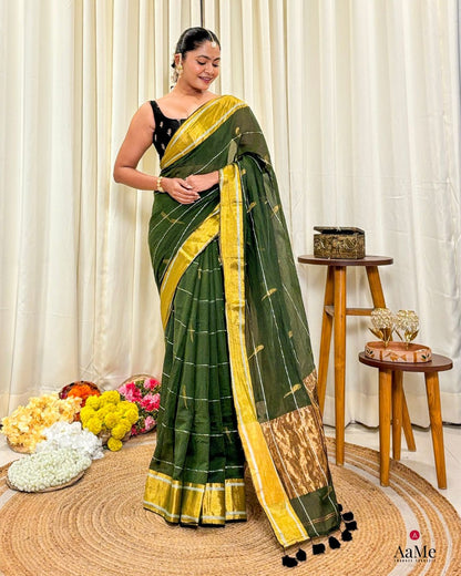 Woman wearing Lightweight green mulmul cotton saree, handcrafted for comfort and styled for celebrations and casual functions