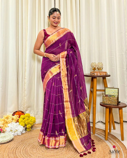 Women wearing handcrafted purple mulmul cotton saree with golden border for festive and elegant daytime occasions