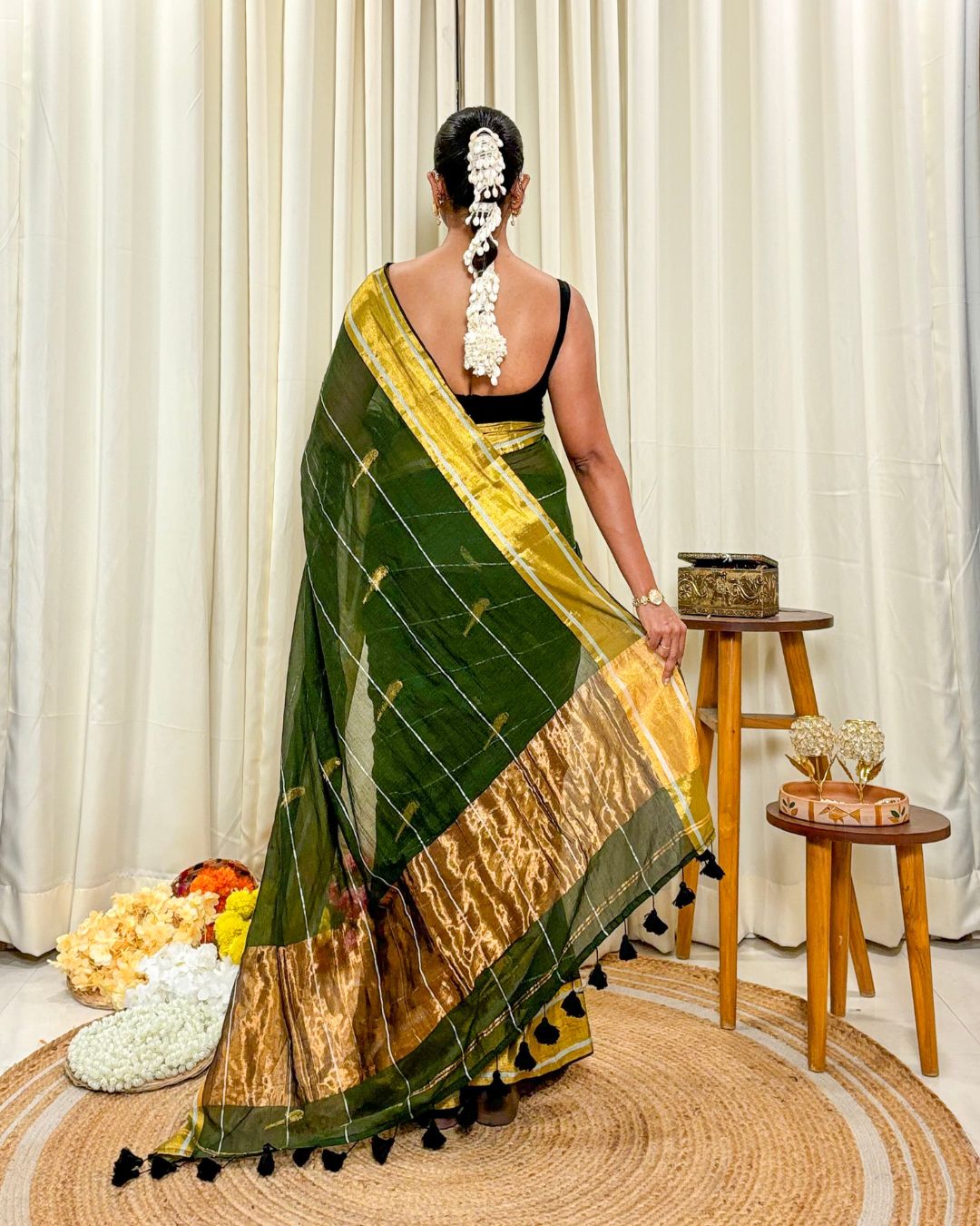 Woman styling The Garden Parrot green mulmul saree for a minimalist ethnic look 