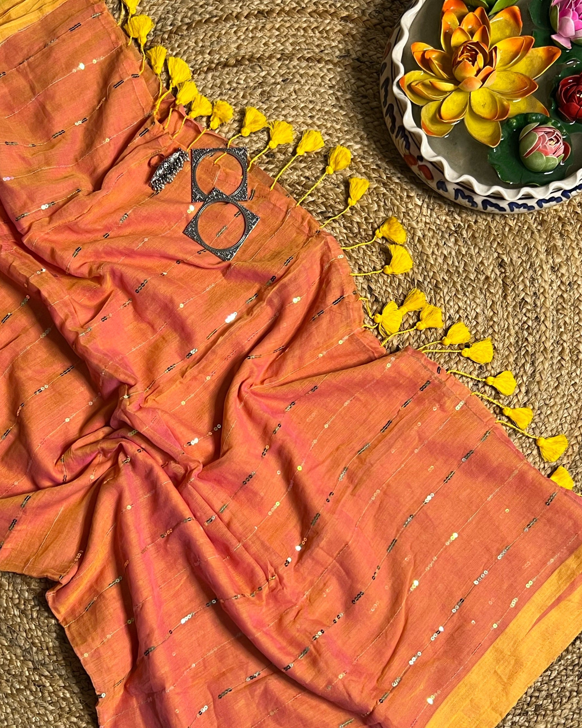 Soft and Comfortable mulmul cotton saree in peach yellow shade with sequin emblishment for festive or party wear at reasonable price