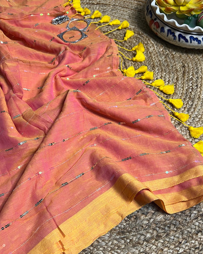 Soft and Comfortable mulmul cotton saree in peach yellow shade with sequin emblishment for festive or party wear at reasonable price