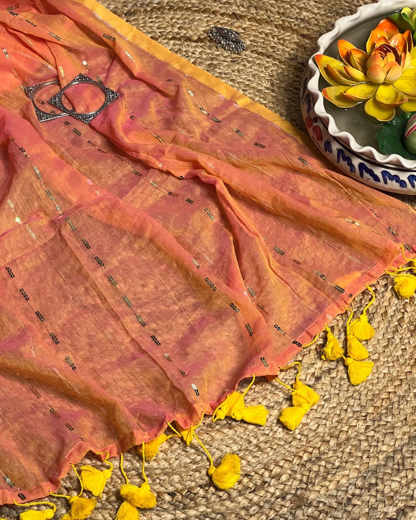 Soft and Comfortable mulmul cotton saree in peach yellow shade with sequin emblishment for festive or party wear at reasonable price