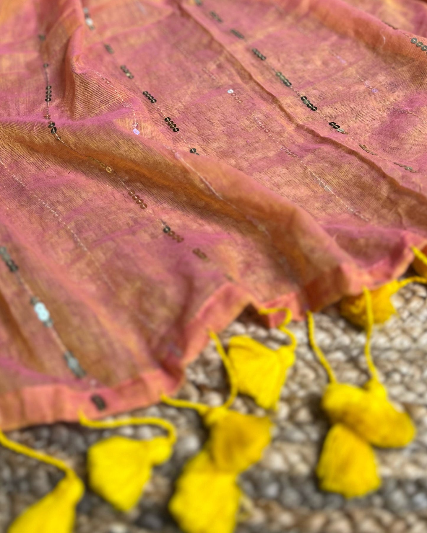 Soft and Comfortable mulmul cotton saree in peach yellow shade with sequin emblishment for festive or party wear at reasonable price