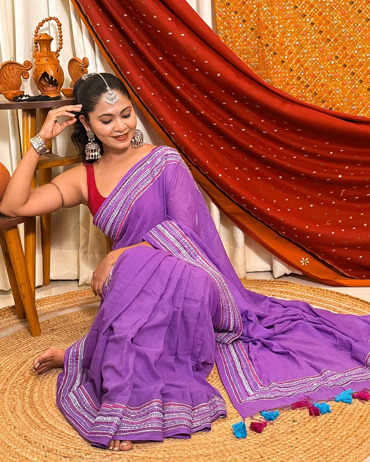 Woman in a lavender mulmul cotton saree with sequins embellished border - festive saree