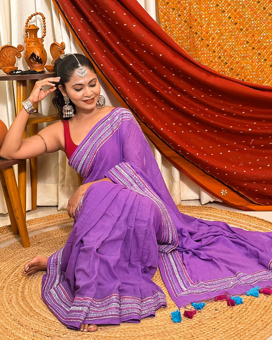 Woman in a lavender mulmul cotton saree with sequins embellished border - festive saree