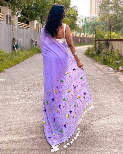 women wearing Mauve embroidered mulmul cotton saree with light patterns in the street
