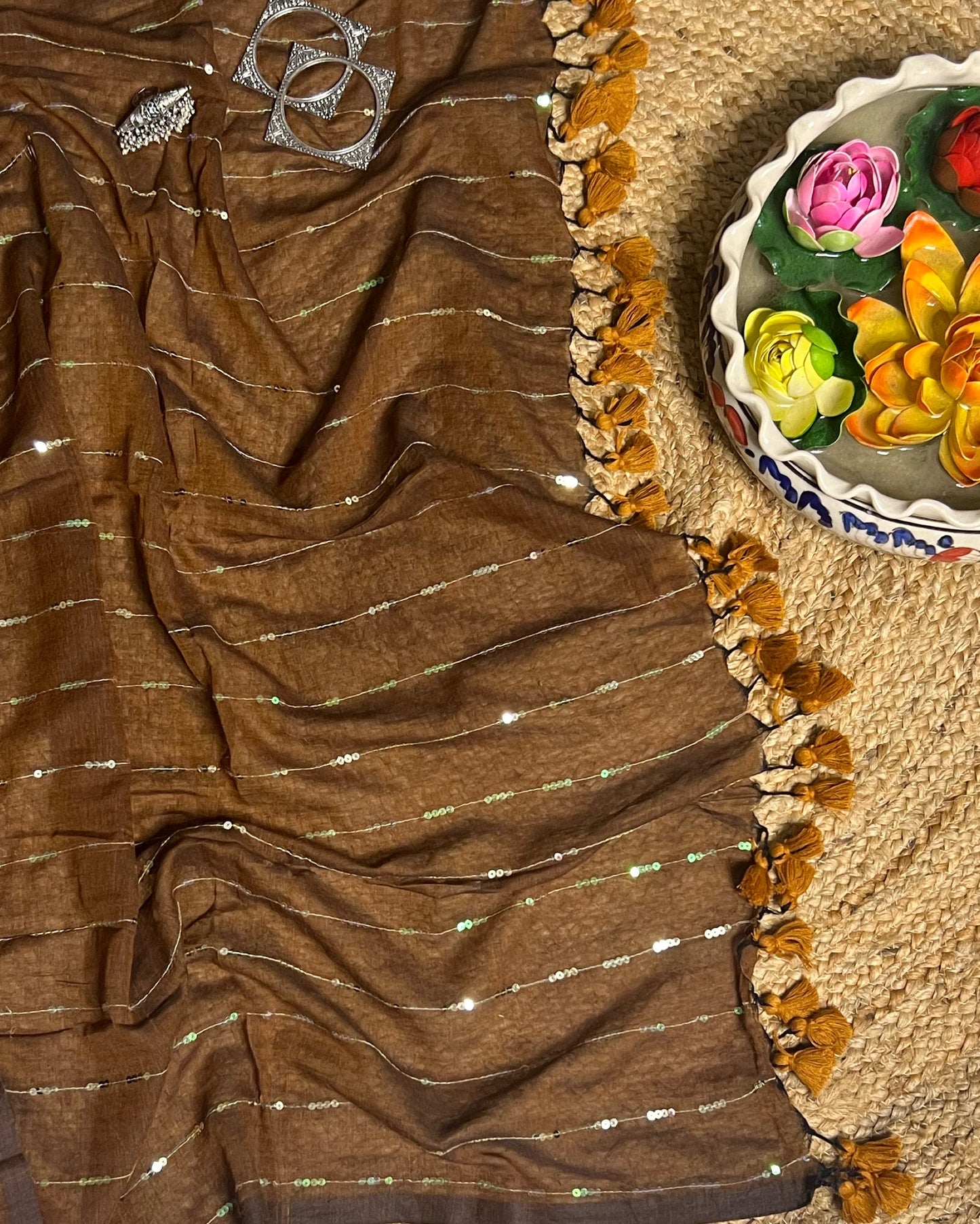 Soft and Comfortable mulmul cotton saree in brown shade with sequin emblishment for festive or party wear at reasonable price