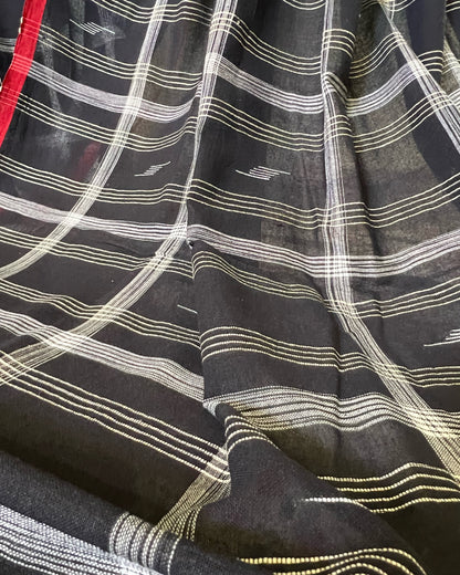 Close-up of black fabric with white and gold stripes