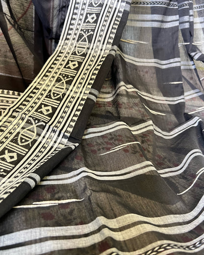 Khadi cotton saree with intricate patterns and colors, featuring a mix of black, white, and brown.