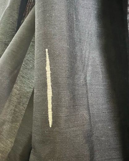 Close-up of black khadi cotton saree with a gold stripe