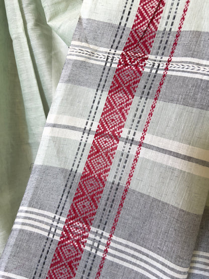 Close-up of a white khadi cotton saree with red, gray, and white pattern.
