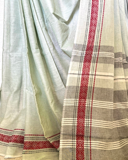 Light khadi cotton saree with red and white geometric patterns on a plain background