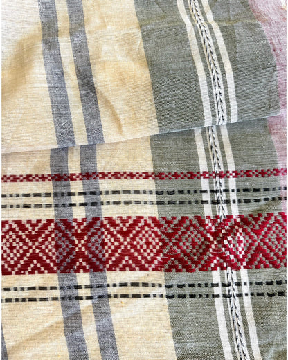 Close-up of pink khadi cotton saree with red, black, and beige patterns