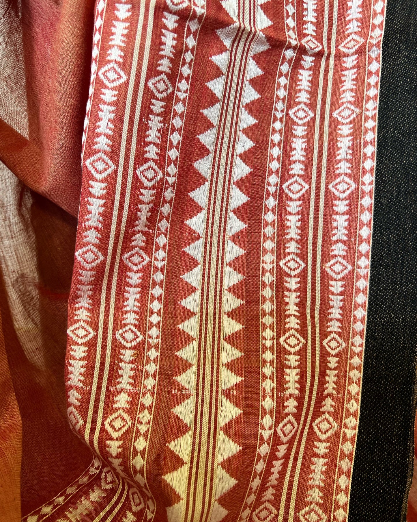 Close-up of khadi cotton saree with red and white geometric pattern
