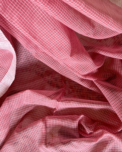 Close-up of pink checkered handloom cotton saree with a soft focus