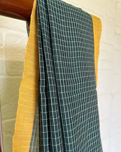 Green checkered handloom cotton saree with yellow border on a white background