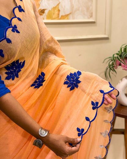 Amber Azure (Peach Hand Embroidered Mulmul Saree)