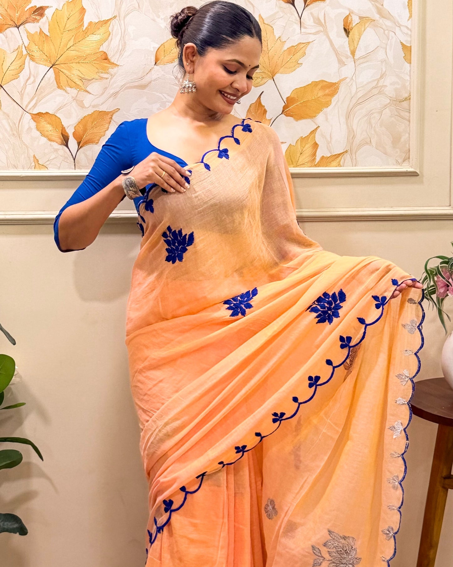 Amber Azure (Peach Hand Embroidered Mulmul Saree)