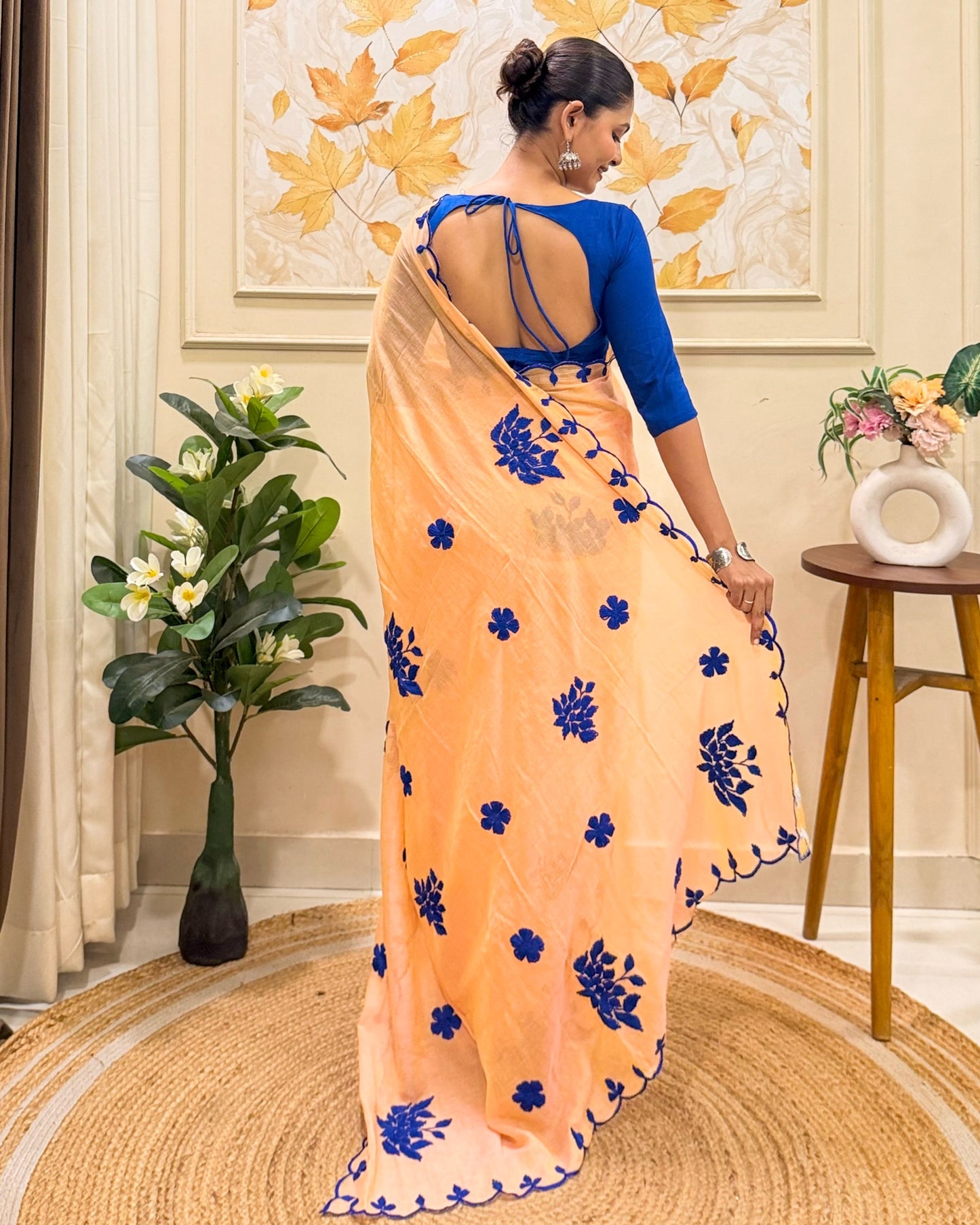 Amber Azure (Peach Hand Embroidered Mulmul Saree)
