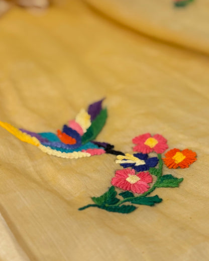 Colorful embroidered flowers and feathers on a yellow mulmul cotton saree by Shopaame